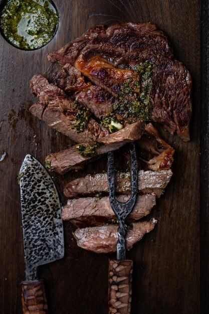 Slices of steak on dark wooden board