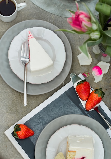 slices of strawberry cake dessert with tulips flowers. 