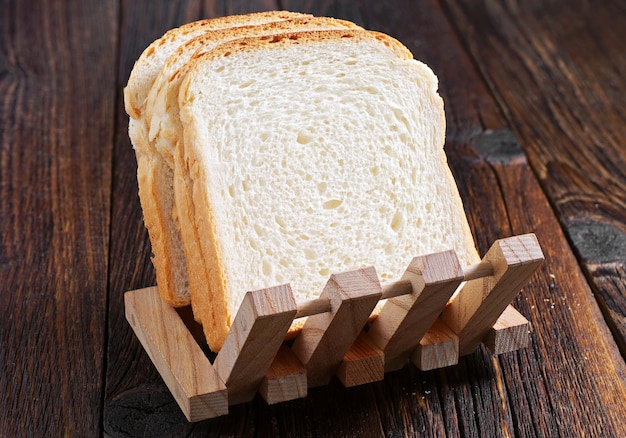 Slices of toast bread on wooden background