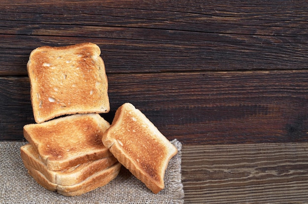 Slices of toasted bread on the dark wooden table Space for text