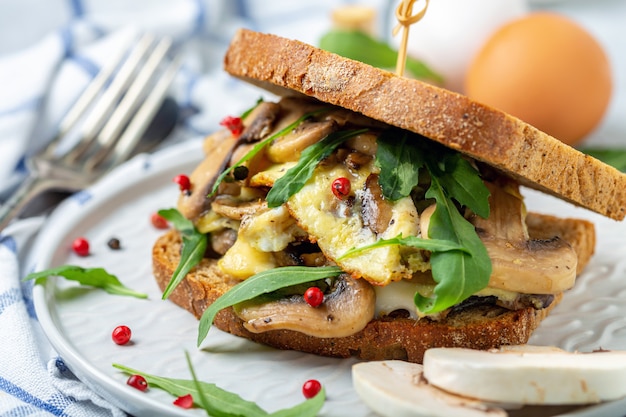 Slices of toasted bread with egg and mushrooms.