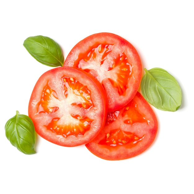 Slices of tomato and basil leaves isolated over white background.