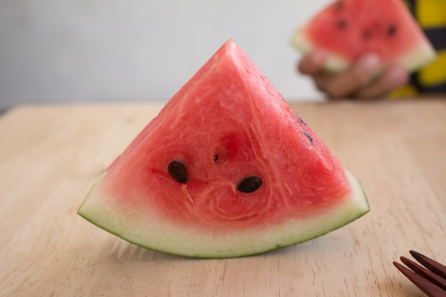 Slices of watermelon on wooden desk background