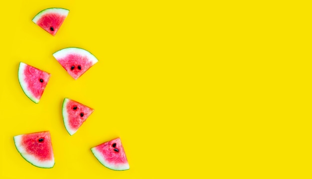 Slices of watermelon on yellow background. Top view