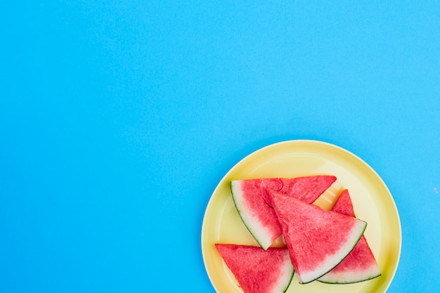 Slices watermelon on yellow plate