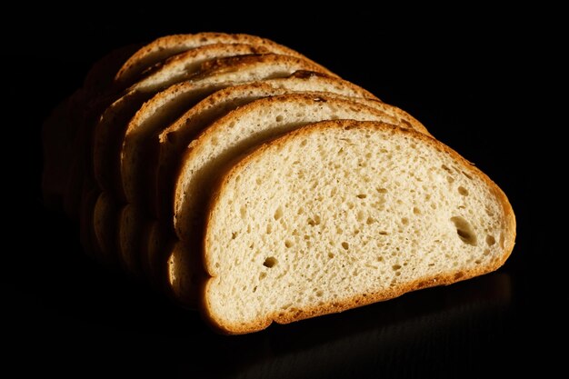 Slices of white bread on a dark background