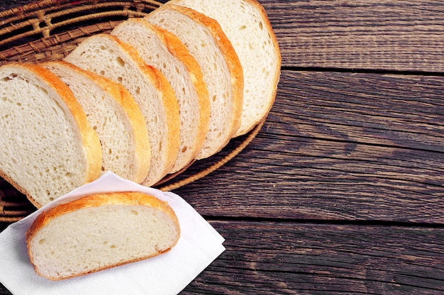 Slices white bread on vintage wooden table