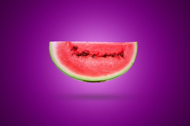 Slicewatermelon on a violet . Artistic .