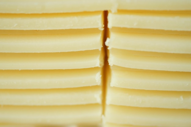 Slicing cheese into pieces closeup