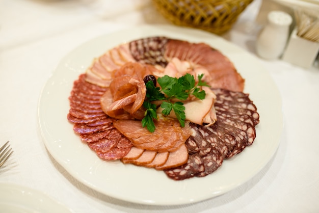 Slicing meat and sausage.