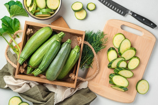 Slicing zucchini on a cutting board. Ripe zucchini on a gray background. Top view, horizontal.