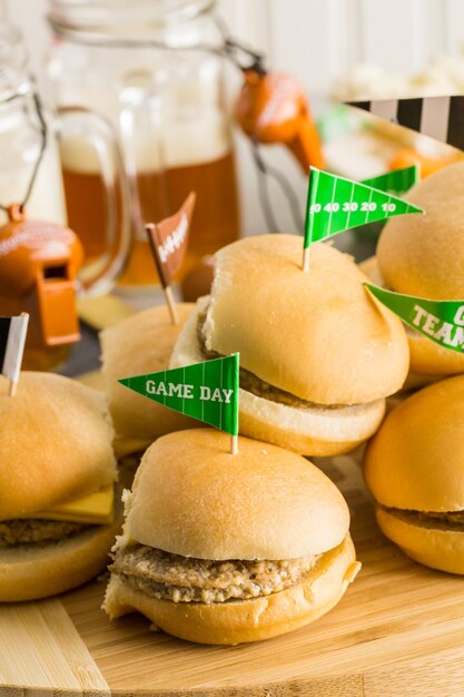 Sliders with veggie tray on the table for the football party.