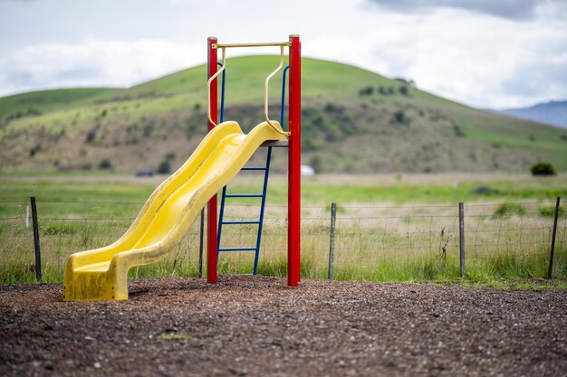 Slides and swings in a playground in a park in australia