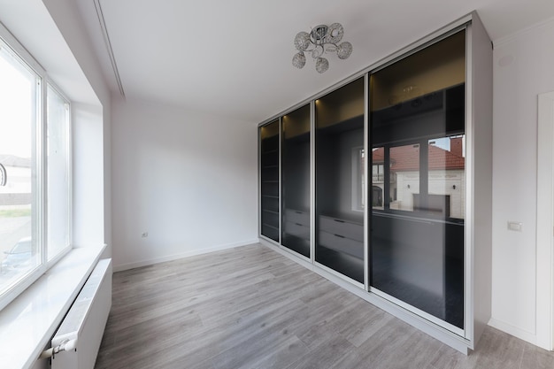 Sliding door wardrobe with glass doors in the room