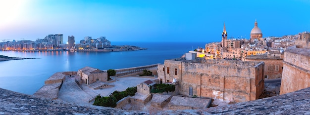 Sliema and Old town of Valletta with churches of Our Lady of Mount Carmel and St. Paul's Anglican Pro-Cathedral in Valletta, Capital city of Malta