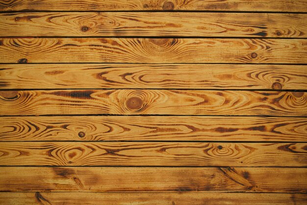 Slightly burned wooden planks surface texture background for design