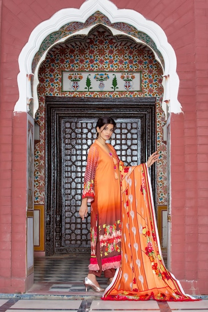 Slim Girl Side Pose Wearing Full Desi Dress for Fashion Shoot at a Beautiful Ancient Place