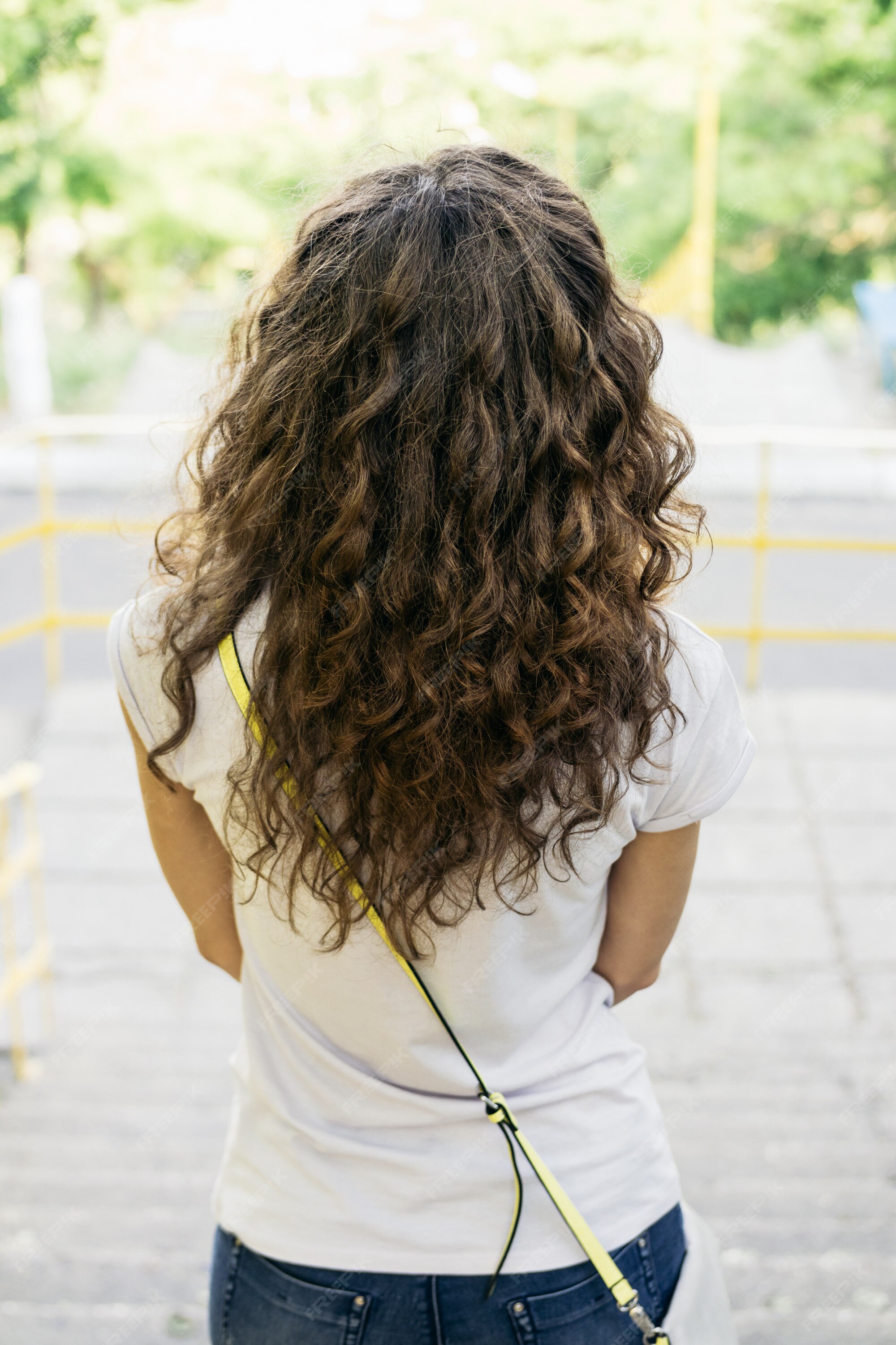 Premium Photo | Slim girl with curly hair in a t-shirt and jeans on a walk Premium Photo | Slim girl with curly hair in a t-shirt and jeans on a walk