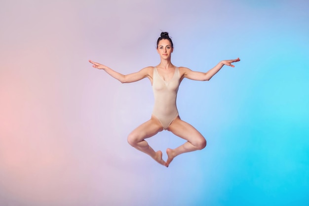 Slim gymnast in beige swimsuit