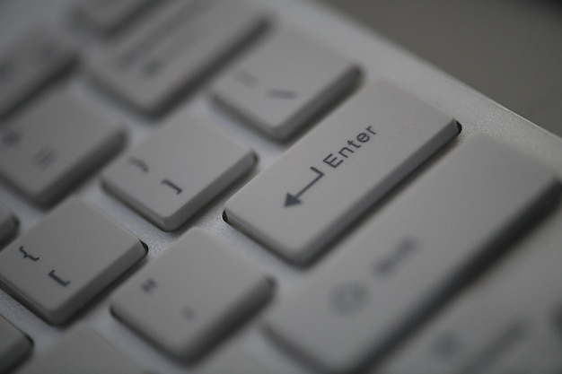 slim white minimalistic keyboard close up  in dark night lit by screen light