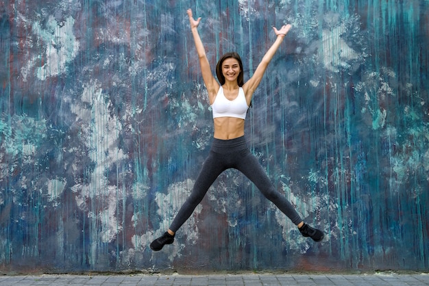 Slim woman in sportswear making exercises