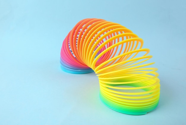 Slinky rainbow spiral on blue background