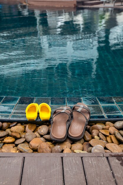 Slippers on edge of pool