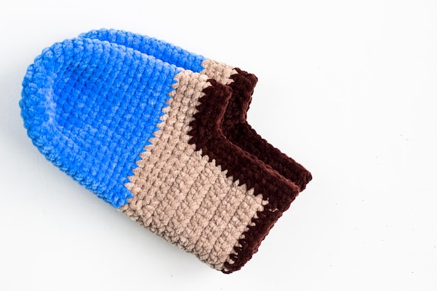 Slippers made of blue and brown plush yarn Knitted slippers on a white background