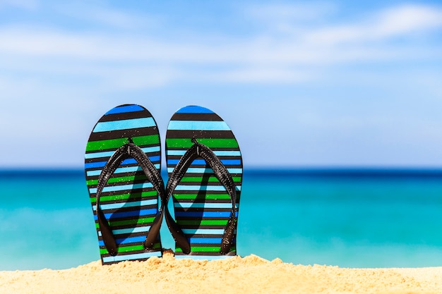 Slippers op het zandstrand