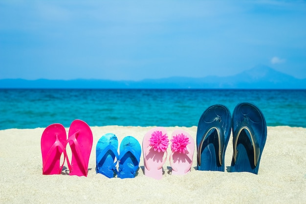 slippers in the sand by the sea greece