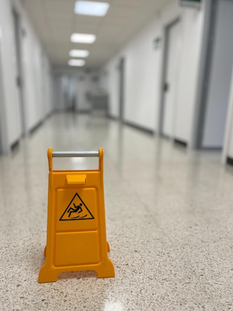 Slippery sign on wet floor in office building