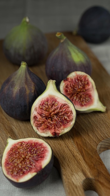 slised figs closeup lies on a wooden kitchen board