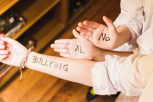 Slogan against bullying written on children's hands