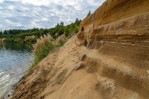 The slope of the picturesque sandy steep shore near the lake