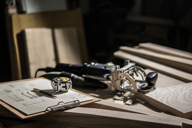 Slotter, tape measure and pencil, drawings on the workbench