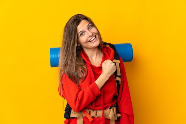 Slovak mountaineer woman with a big backpack isolated