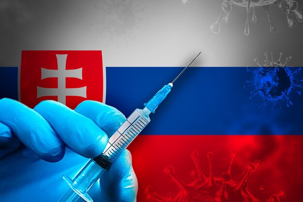 Slovakia covid19 vaccination campaign hand in a blue rubber glove holds syringe in front of flag