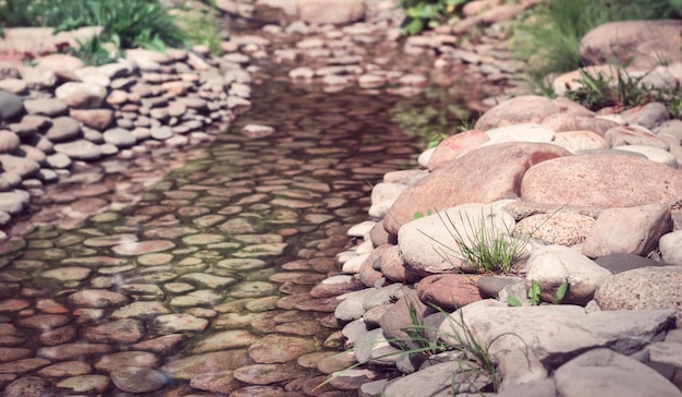 Slow trickle with large pink pebble