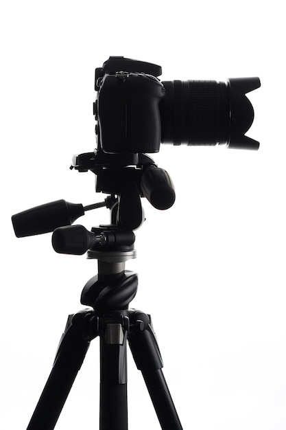 SLR camera on tripod isolated on white