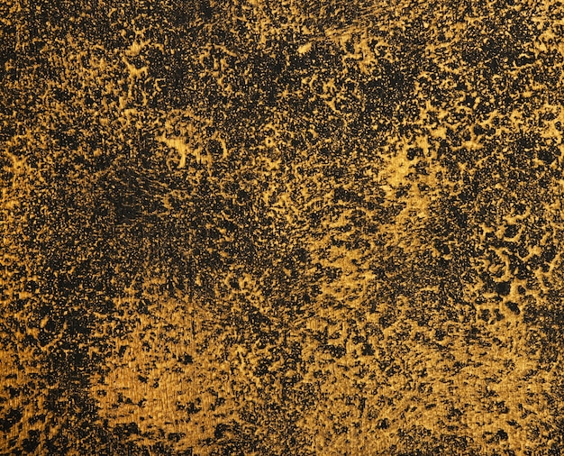 Sluit omhoog abstracte grunge gouden en zwarte achtergrond met penseelstreek en ploetert patroon