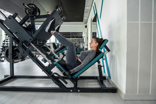 Sluit omhoog beeld van aantrekkelijke geschikte vrouw in gymnastieklessen in de gymnastiek gezonde levensstijl een meisje met een mooi figuur