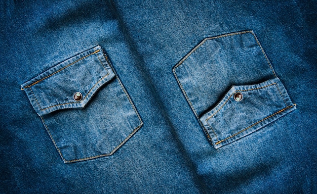 Sluit omhoog de textuurachtergrond van denimjeansjeans