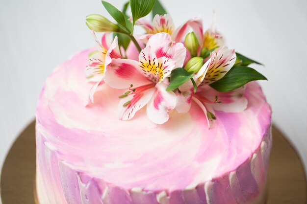 Sluit omhoog op cake met roze decor en bloemen