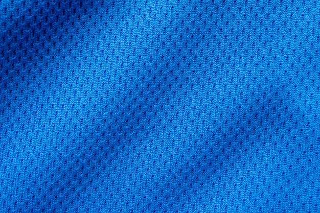 Sluit omhoog op de blauwe textuur van het voetbalshirt