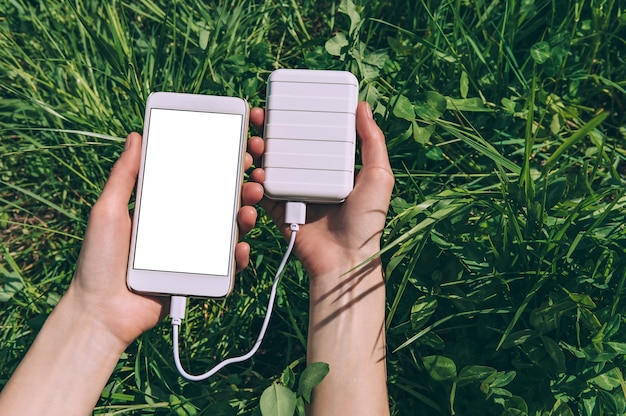 Foto sluit omhoog op lege mobiele telefoon met in hand gehouden machtsbank