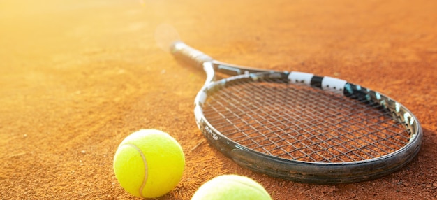 Sluit omhoog van tennisracket en ballen op het tenniskleigrond of hofsportconcept