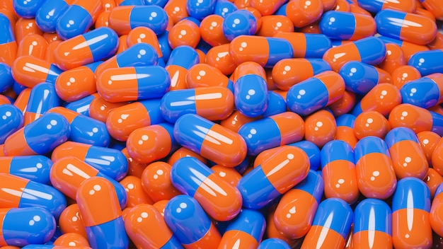 Sluit omhoog van vele oranje en blauwe pillencapsules