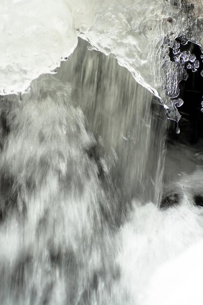 A small active waterfall Clean mountain stream snowy winter landscape wildlife background