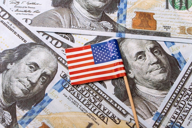 Small American flag on the background of dollars