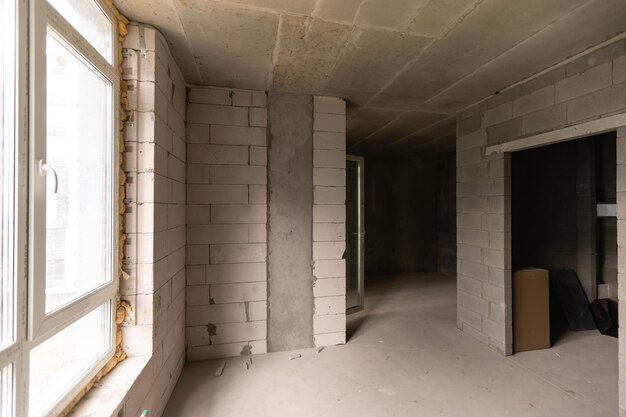 Small apartment without repair in a new building. A room in an unfinished house. Walls of foam block and concrete floor in a tiny apartment.